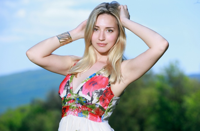 Woman with blonde hair wearing a floral dress