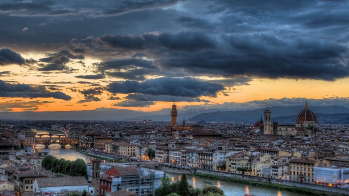 Florence cityscape with Arno River and Ponte Vecchio at sunset