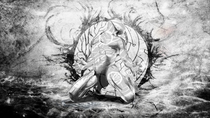 Man with white markings kneeling in front of a circular design