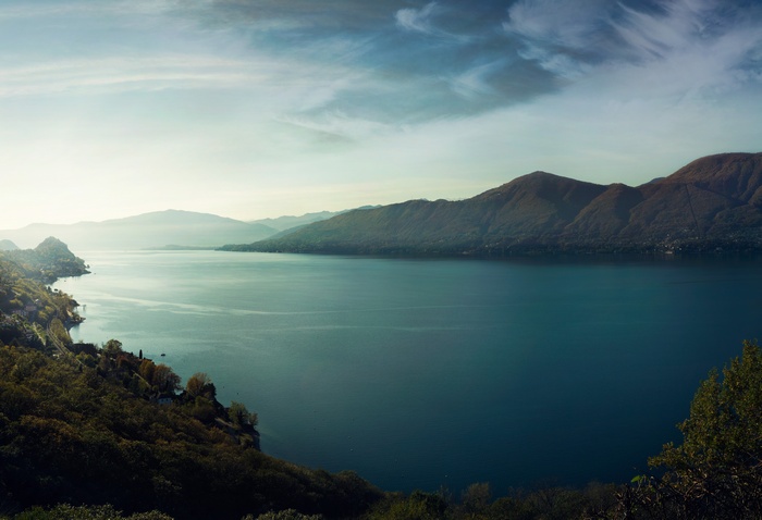 Lake and mountains landscape with trees and sky