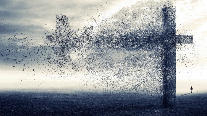 A cross disintegrating into birds with a man in the distance
