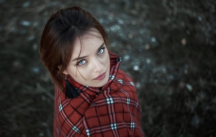 Portrait of a woman with blue eyes wearing a red plaid coat