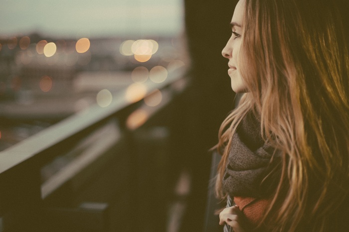 Woman looking out at city lights