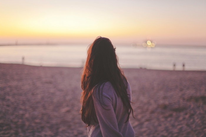 Woman on a beach at sunset