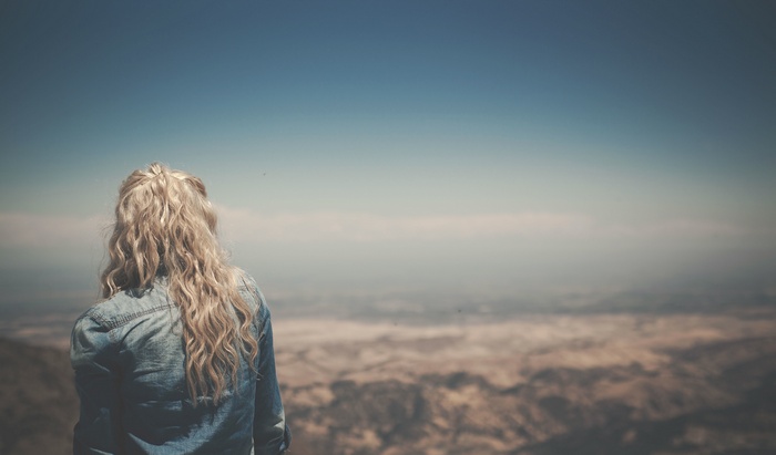 Woman with blonde hair looking at the landscape