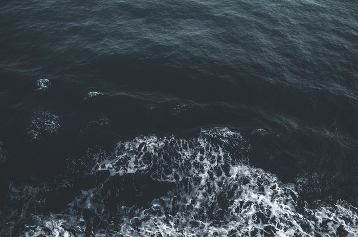 Dark ocean waves with white foam