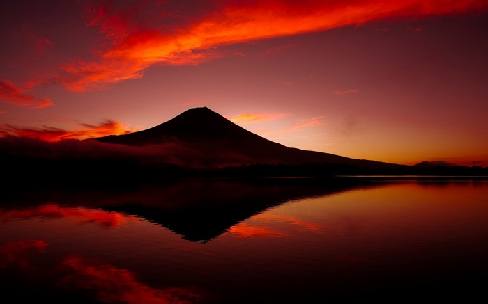 Mount Fuji reflected in a lake at sunset