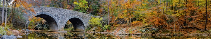 Stone bridge over a stream in Philadelphia during fall
