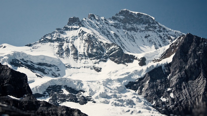 Snow-covered mountains under a clear blue sky