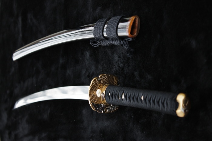Katana sword and scabbard on black background
