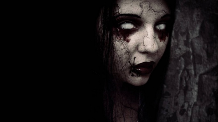 Creepy zombie woman with cracked skin and white eyes