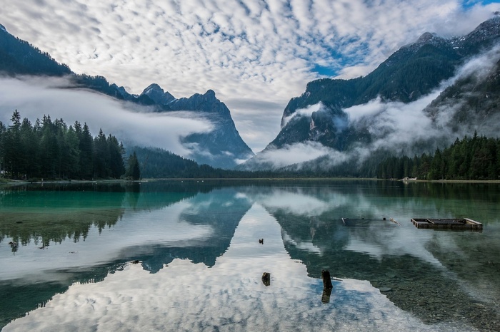 Lake with mountains and clouds reflection in Italy