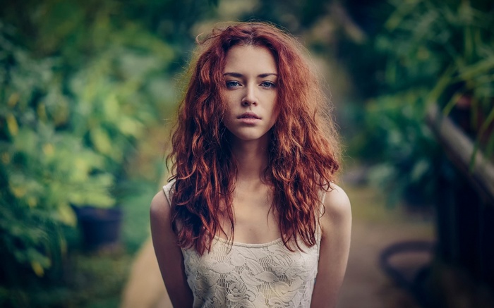 Anna Zabolotskaya with long red hair and blue eyes