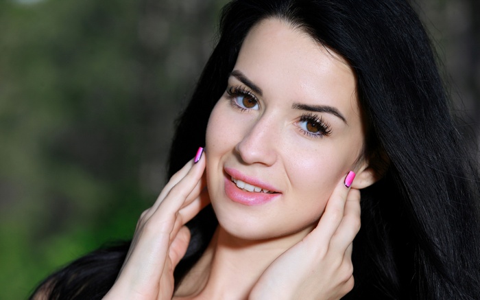 Lola Marron smiling with hands on her face outdoors