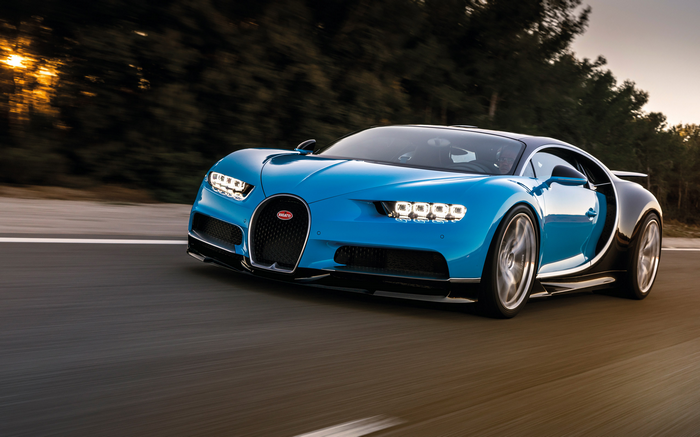 Blue Bugatti Chiron driving on a road