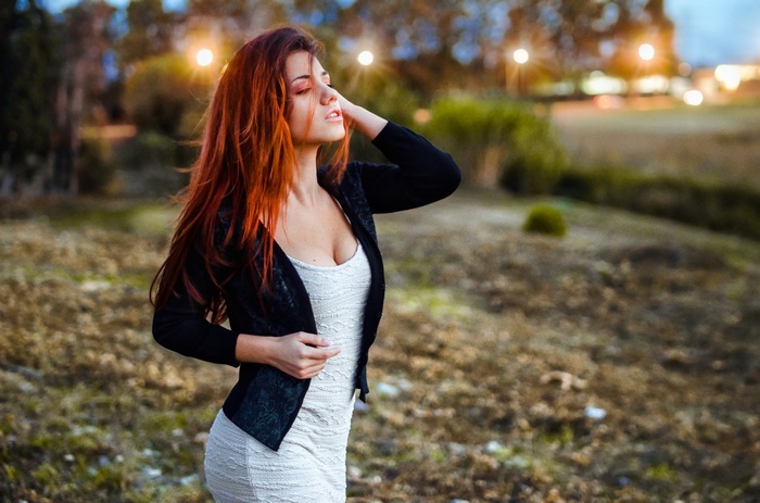 Redhead woman with long hair wearing a dress