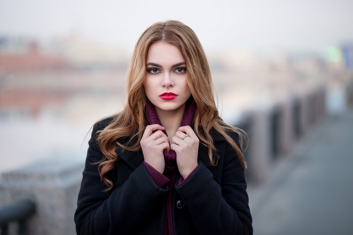 Oktyabrina Maximova in a black coat with red lipstick