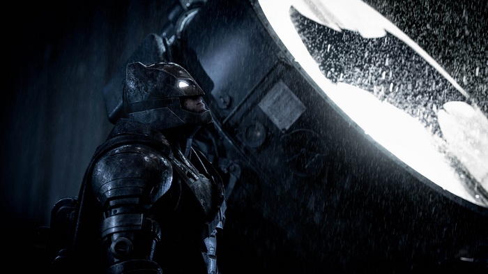Batman in his armored suit with the Bat-Signal