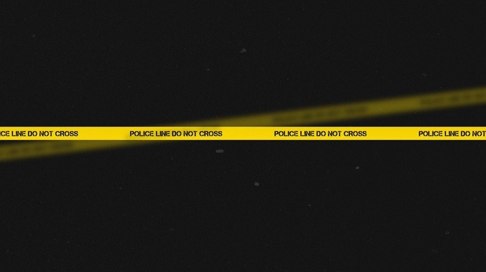 Yellow police line do not cross tape on black background