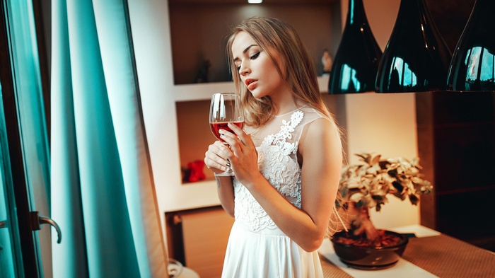 Maria Puchnina holding a glass of red wine