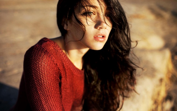 Emily Rudd wearing a red sweater