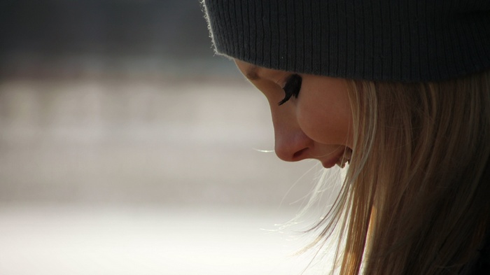 Girl with blonde hair wearing a beanie