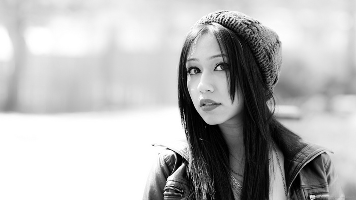 Monochrome portrait of a brunette woman wearing a beanie