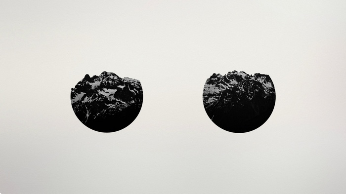 Two circular mountain landscapes in black and white
