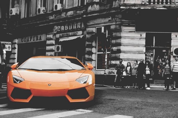 Orange Lamborghini Aventador parked on a street