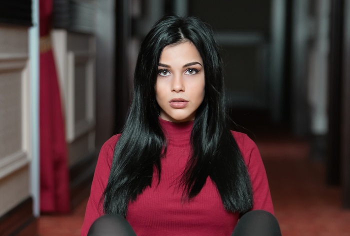 Young woman with black hair and red top
