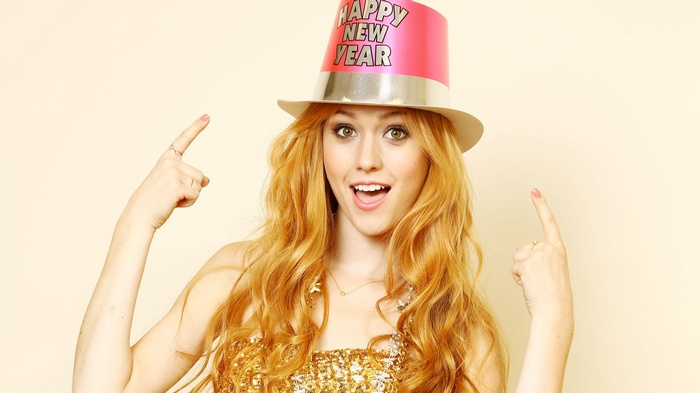 Katherine McNamara wears a Happy New Year hat and gold dress
