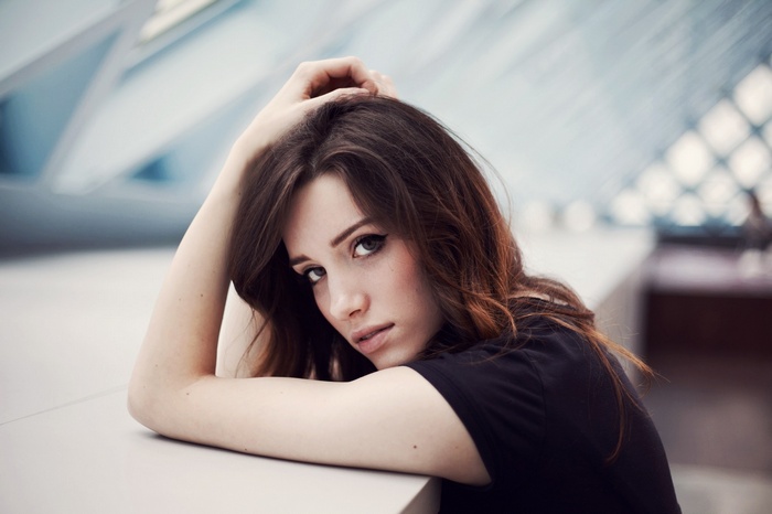 Woman with auburn hair looking at viewer
