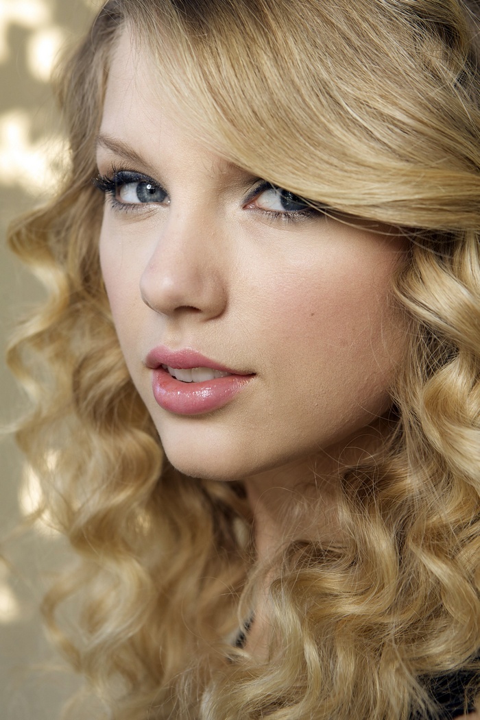 Taylor Swift blonde wavy hair blue eyes portrait