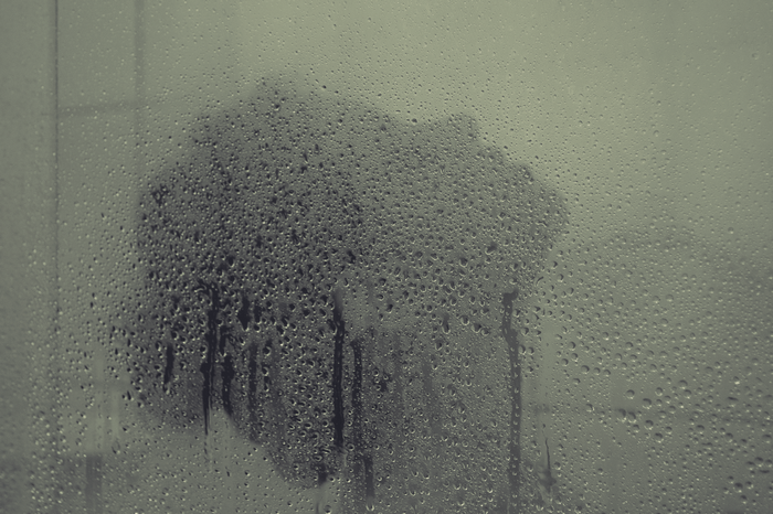 Water drops on a steamy glass surface