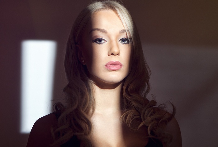 Portrait of a blonde woman with dramatic lighting