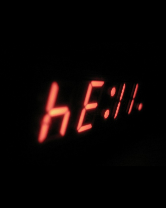 Red digital clock displaying 'hell'