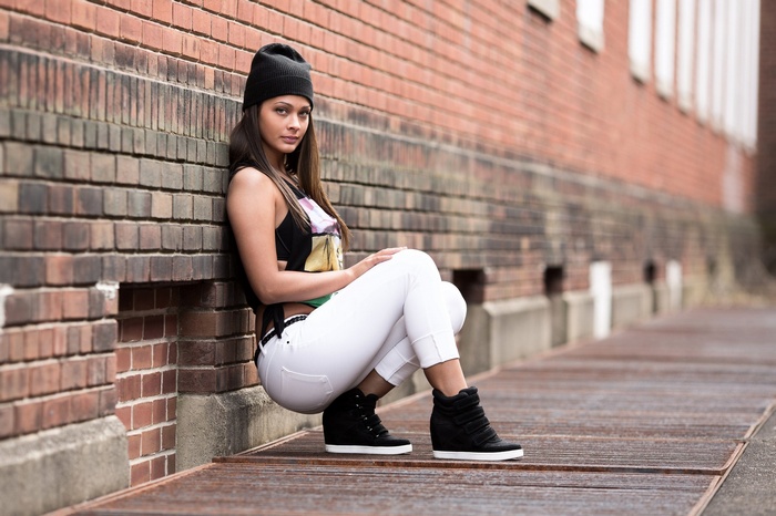 Woman in black beanie and white pants