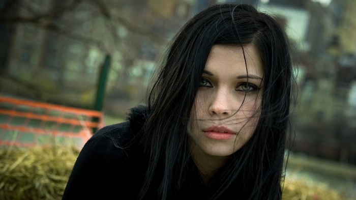 Woman with black hair and green eyes