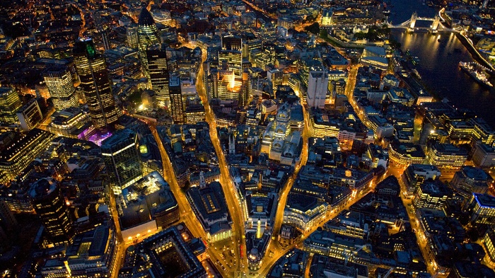 Aerial view of London cityscape at night with city lights