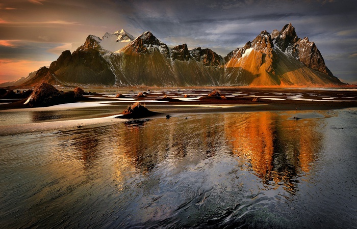 Mountains reflecting in water at sunset
