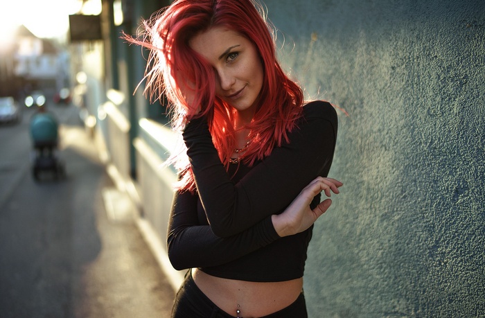 Woman with red hair and pierced navel