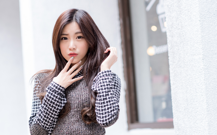 Asian woman with long brown hair outdoors