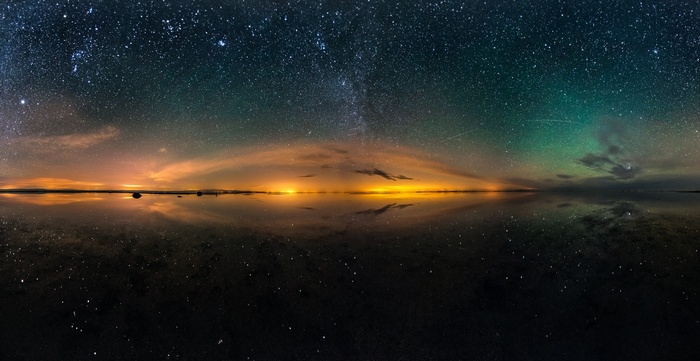 Starry Night Sky Reflected Over a Calm Body of Water