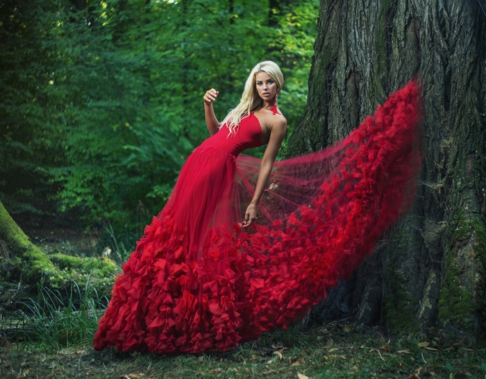 Woman in a red dress in a forest
