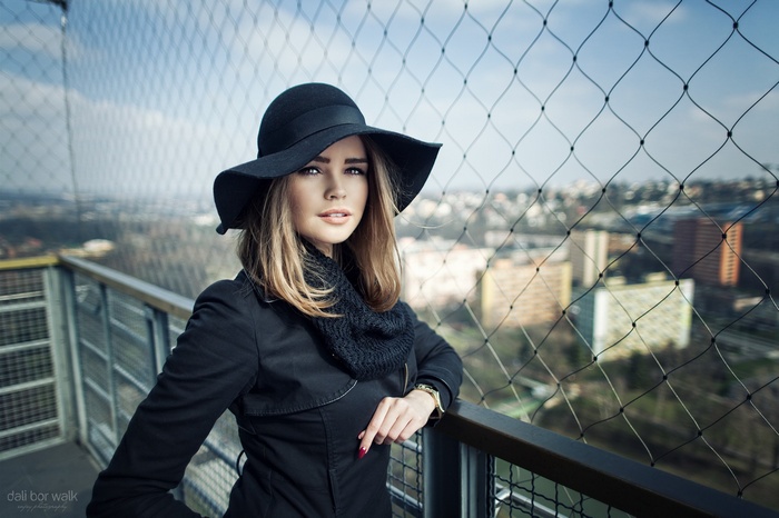 Woman in black hat and coat outdoors