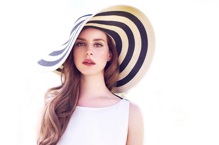 Lana Del Rey wearing a large striped hat