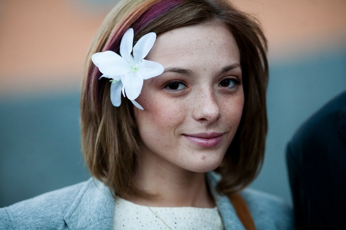 Olga Kobzar with a flower in her hair and freckles