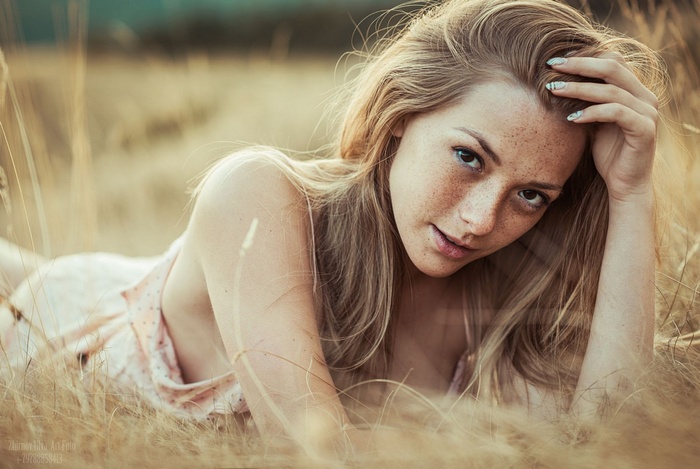 Olga Kobzar lying in a field of grass
