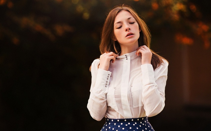 Woman in white shirt and polka dot skirt