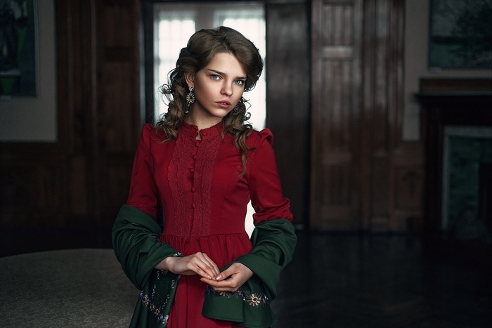 Woman in a red dress with a green shawl